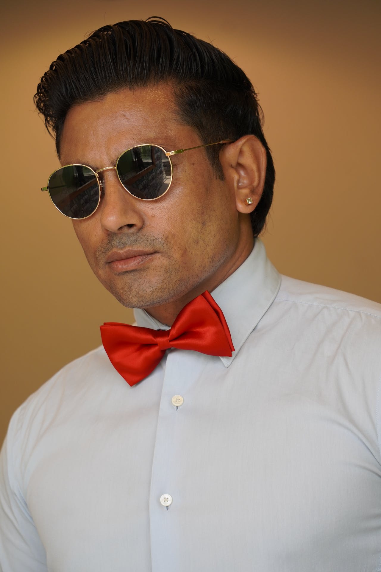 Man in Aviator Sunglasses and Red Bow Tie
