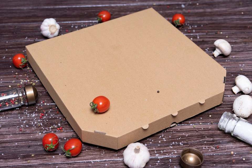 Pizza box, vegetables and spices