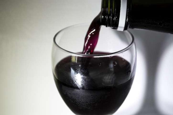 pouring red wine in a glass