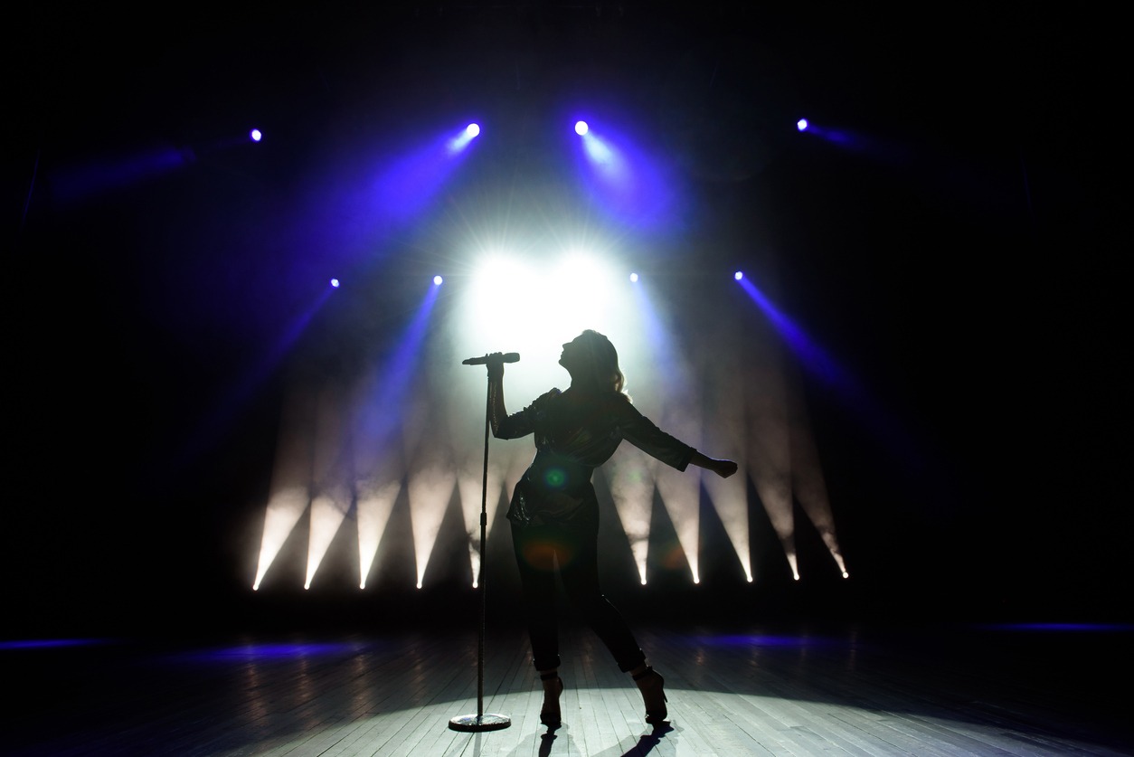 silhouette of a singer on stage