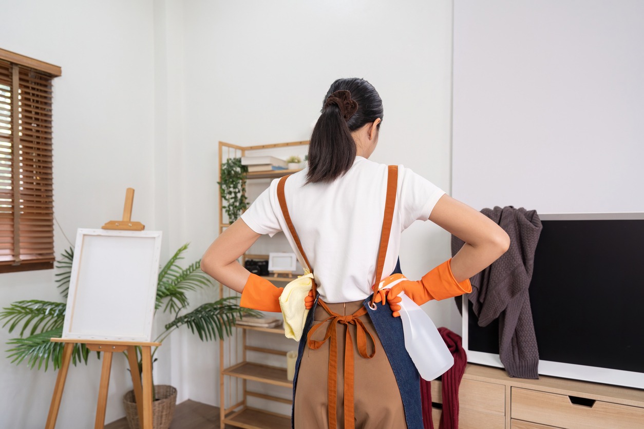 woman looking at the mess in the apartment