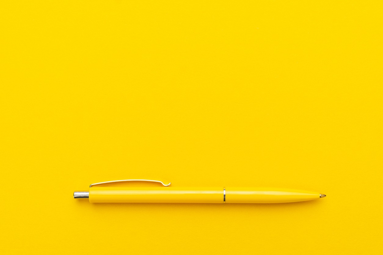 Yellow pen on yellow background
