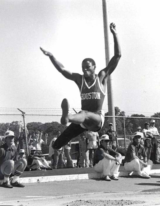 Carl Lewis in midair during a long jump for track and field as an athlete at the University of Houston