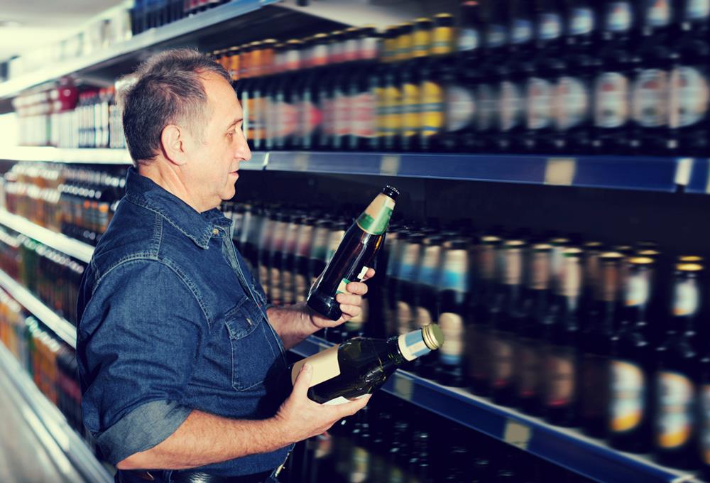 Man choosing a beer from the shelf