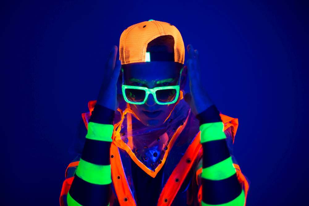 Man wearing neon and glow in the dark accessories